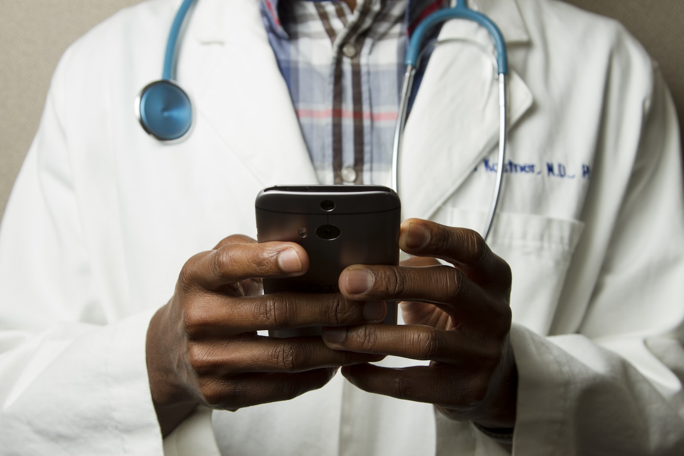 Clinician using a smartphone during a care conversation